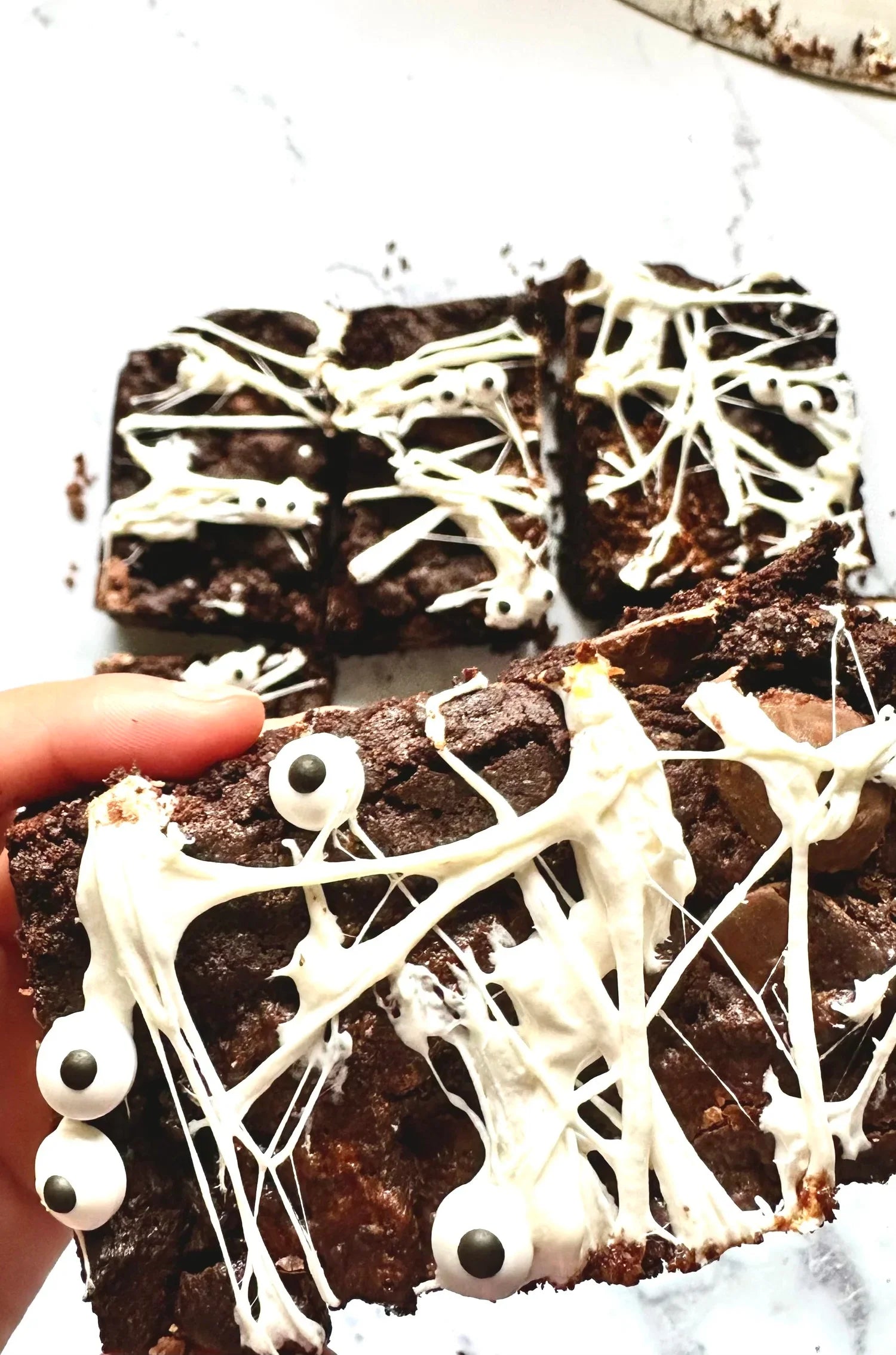 Halloween brownies with marshmallow cobwebs and candy eyes made with Flour and Dough Brownie Mix NZ