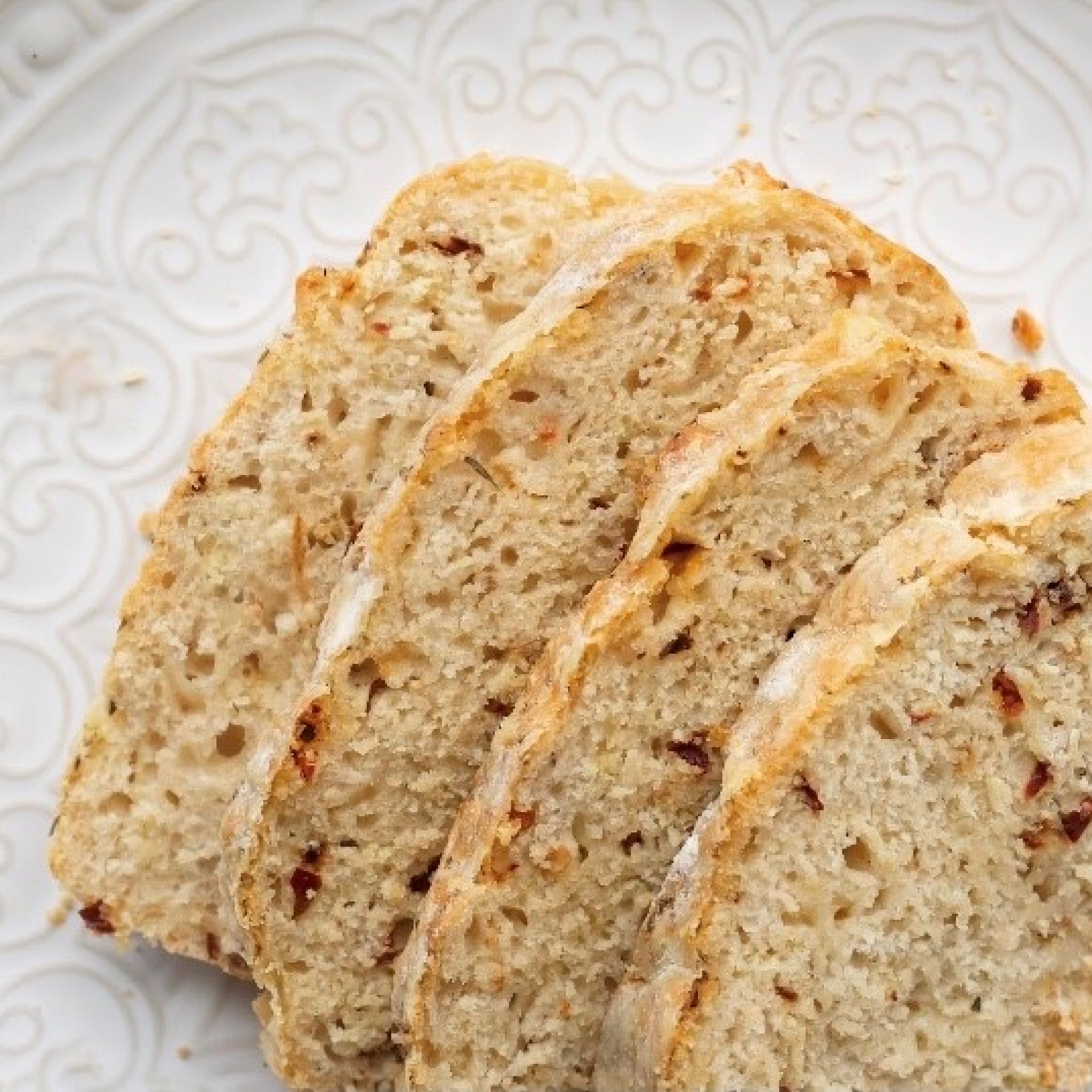 flour and dough chilli and garlic beer bread mix sliced loaf on plate